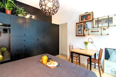 a dining room with a table and a black wall at AibarResidentieJH in Amsterdam