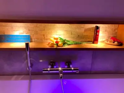 a shelf in a bathroom with flowers on it at OscarReestratResidence in Amsterdam