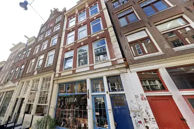 a building on a city street with a store at OscarReestratResidence in Amsterdam