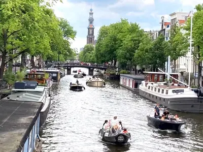 a group of people riding in boats down a canal at OscarReestratResidence in Amsterdam