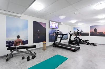 a gym with two treadmills and two exercise bikes at Urban Lodge Hotel in Amsterdam