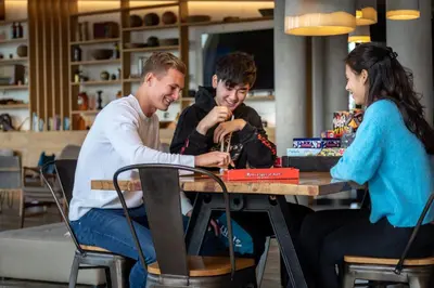 a group of three people sitting at a table at Urban Lodge Hotel in Amsterdam