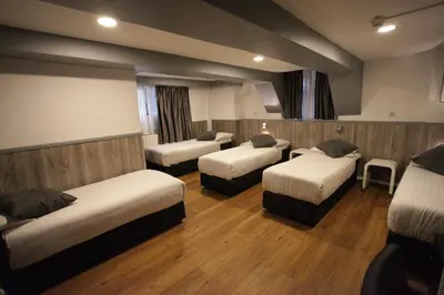 a room with four beds in a room at Travel Hotel Amsterdam in Amsterdam