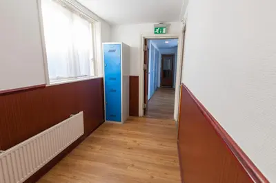 an empty hallway with a blue elevator in a building at Travel Hotel Amsterdam in Amsterdam
