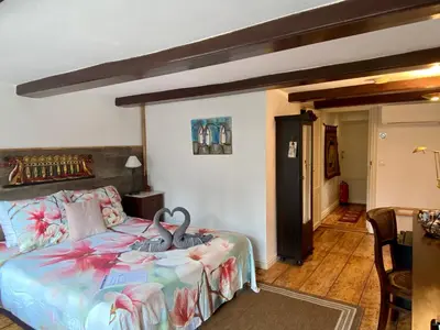 a bedroom with a bed with swans on it at Amsterdam Barangay in Amsterdam
