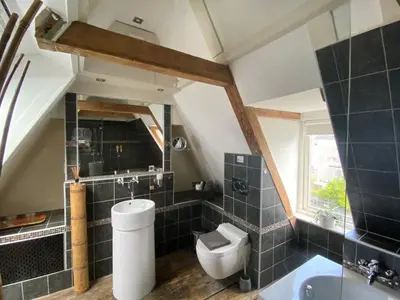 a bathroom with a toilet and a sink at Amsterdam Barangay in Amsterdam