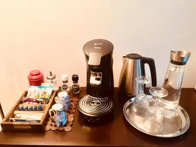 a coffee maker sitting on top of a wooden table at Amsterdam Barangay in Amsterdam