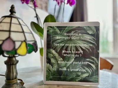 a sign sitting on a table next to a lamp at Amsterdam Barangay in Amsterdam