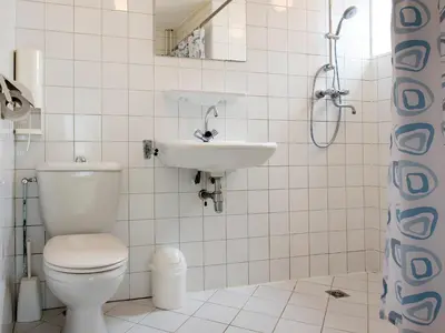 a bathroom with a toilet and a sink at Egmond-vakantiewoningen in Egmond aan Zee