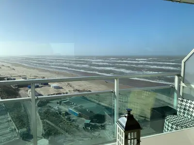 a view of the beach from the balcony of a building at Studio Coastview in Zandvoort