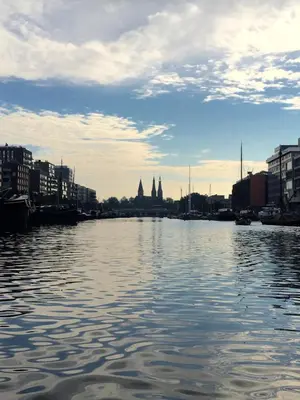 a view of a river with buildings and a city at Houseboat Westerdok in Amsterdam