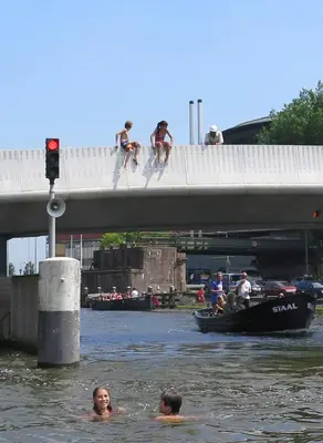 a group of people in the water on a bridge at Houseboat Westerdok in Amsterdam