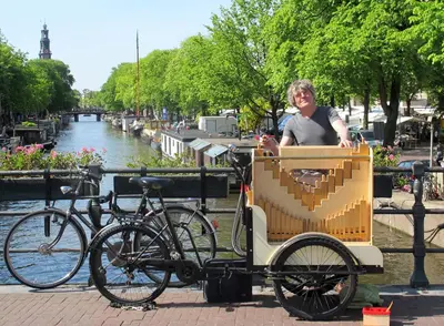 a woman is sitting in a box on a bike at Houseboat Westerdok in Amsterdam