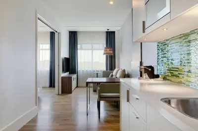 a kitchen with a sink and a table with chairs at Element Amsterdam in Amsterdam