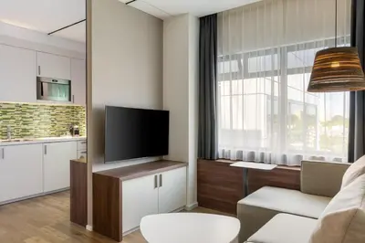 a living room with a flat screen tv and a couch at Element Amsterdam in Amsterdam