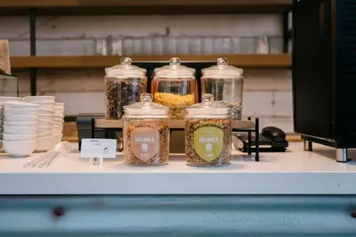 a display of jars of food on a table at Element Amsterdam in Amsterdam