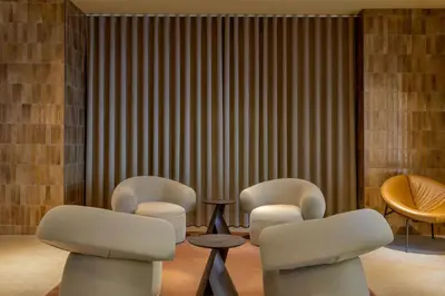 a waiting room with three chairs and a table at Amsterdam Marriott Hotel in Amsterdam