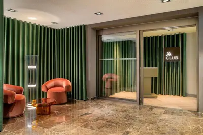 a room with two chairs and a window with a club at Amsterdam Marriott Hotel in Amsterdam