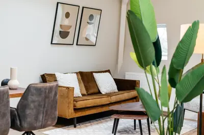 a living room with a couch and a table at UtrechtCityApartments – Weerdsingel in Utrecht