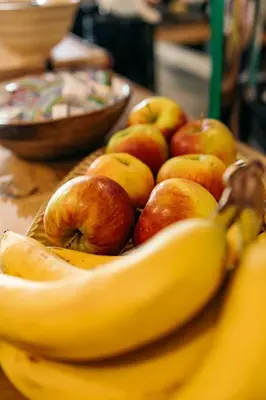 a bowl of apples and bananas on a table at The Flying Pig Beach Hostel Age 18 to 40 in Noordwijk aan Zee