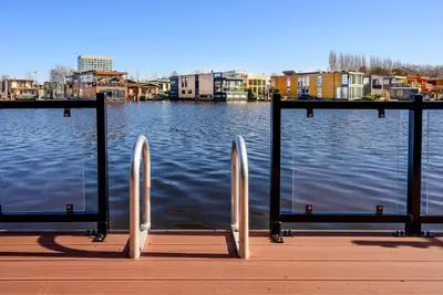 a dock with a view of a body of water at Houseboat studio with canalview and free bikes in Amsterdam