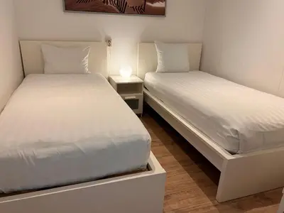 two beds sitting next to each other in a room at Zandvoort Station Apartment in Zandvoort