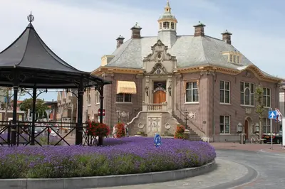 a large building with purple flowers in front of it at Zandvoort Station Apartment in Zandvoort