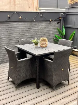 a table with wicker chairs on a patio at Zandvoort Station Apartment in Zandvoort
