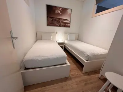 a small room with two beds in it at Zandvoort Station Apartment in Zandvoort