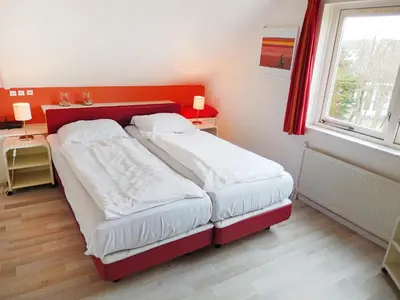 a small bedroom with two beds and a window at Holiday Home Stern Comfort-1 by Interhome in Noordwijk