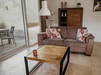 a living room with a couch and a coffee table at Holiday Home De Zeeparel by Interhome in Egmond aan Zee