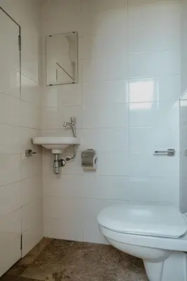 a bathroom with a toilet and a sink at Holiday Home De Zeeparel by Interhome in Egmond aan Zee