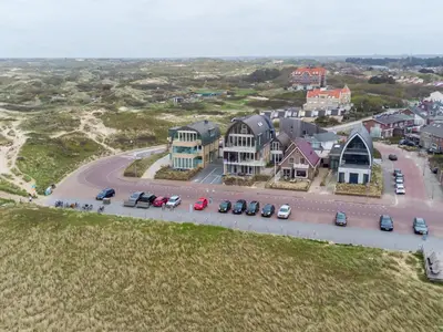 an aerial view of a town with cars parked on a road at Holiday Home De Zeeparel by Interhome in Egmond aan Zee