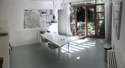 a white table and chairs in a room with a window at Bed of Roses in Amsterdam