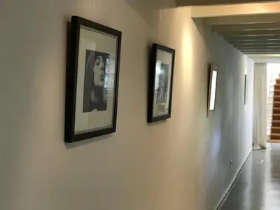 three framed pictures on a wall in a hallway at Bed of Roses in Amsterdam