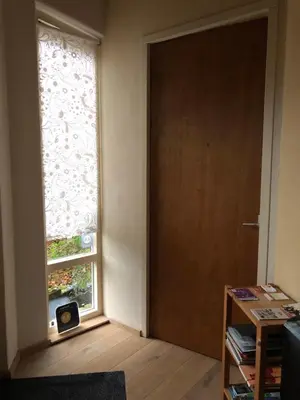 an empty room with a door and a window at B&B 't Buitenkansje in Almere