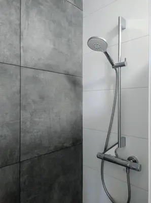 a shower with a shower head in a bathroom at Le-Clochard in Groet