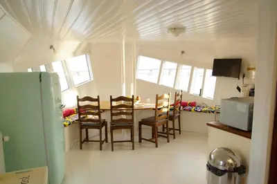 a kitchen and dining room with a table and chairs at The Island Houseboat in Amsterdam