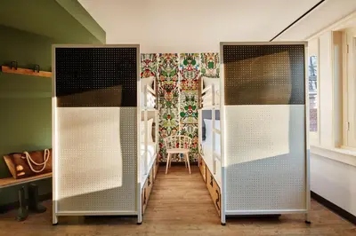 two bunk beds in a room with a chair at Generator Amsterdam in Amsterdam
