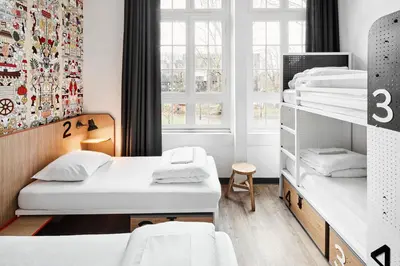 a room with two bunk beds and a window at Generator Amsterdam in Amsterdam
