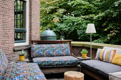 a patio with two couches and a table at Generator Amsterdam in Amsterdam