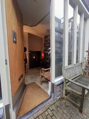 a bench sitting on a porch with a window at Studio53Amsterdam in Amsterdam