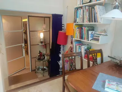a room with a table and book shelves with books at Studio53Amsterdam in Amsterdam