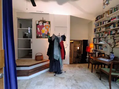 a living room with a desk and a table with clothes hanging at Studio53Amsterdam in Amsterdam