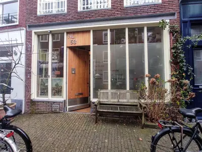 a building with a bench in front of a building at Studio53Amsterdam in Amsterdam