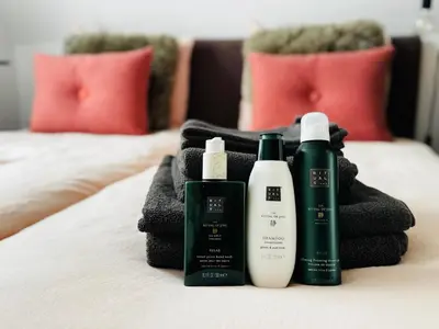 a group of three products sitting on a bed at Betty Blue Bed & Breakfast in Gouda