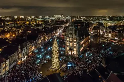 a city lit up at night with a christmas tree at Betty Blue Bed & Breakfast in Gouda