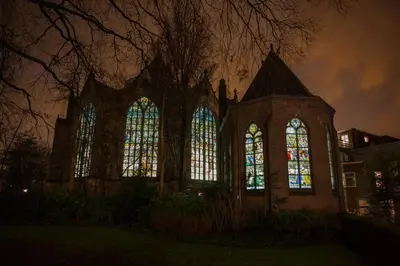 a church with stained glass windows at night at Betty Blue Bed & Breakfast in Gouda