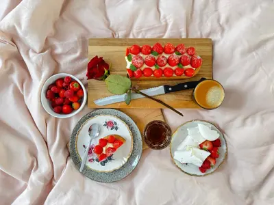 a table with two plates of strawberries and a cake at Betty Blue Bed & Breakfast in Gouda