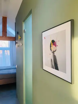 a picture hanging on a wall in a room at Betty Blue Bed & Breakfast in Gouda